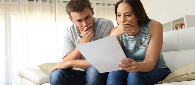 couple looking at foreclosure notice
